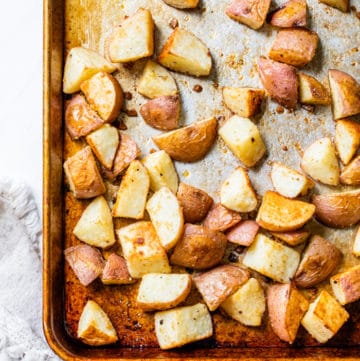 a baking sheet with roasted potatoes