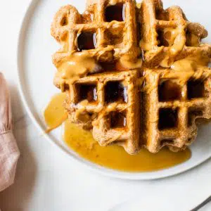 waffles topped with peanut butter and maple syrup