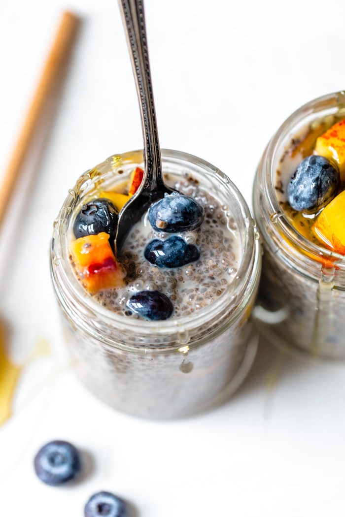 jar of chia seeds and milk with fresh blueberries