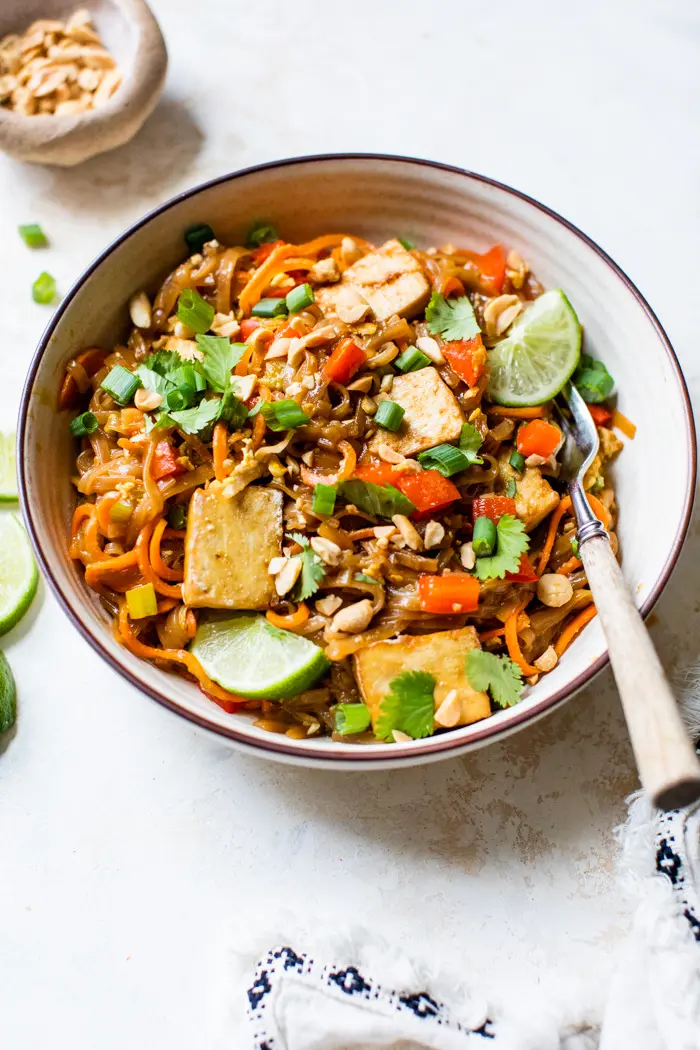 noodles in a bowl with tofu and lime