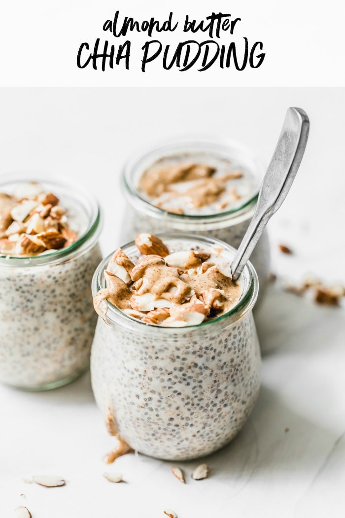 Three jars of chia pudding topped with almonds and almond butter