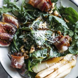 Pear Salad | This fall-flavored salad is topped with pears, fresh figs, bacon-wrapped dates, and a tasty cinnamon dressing! | thealmondeater.com