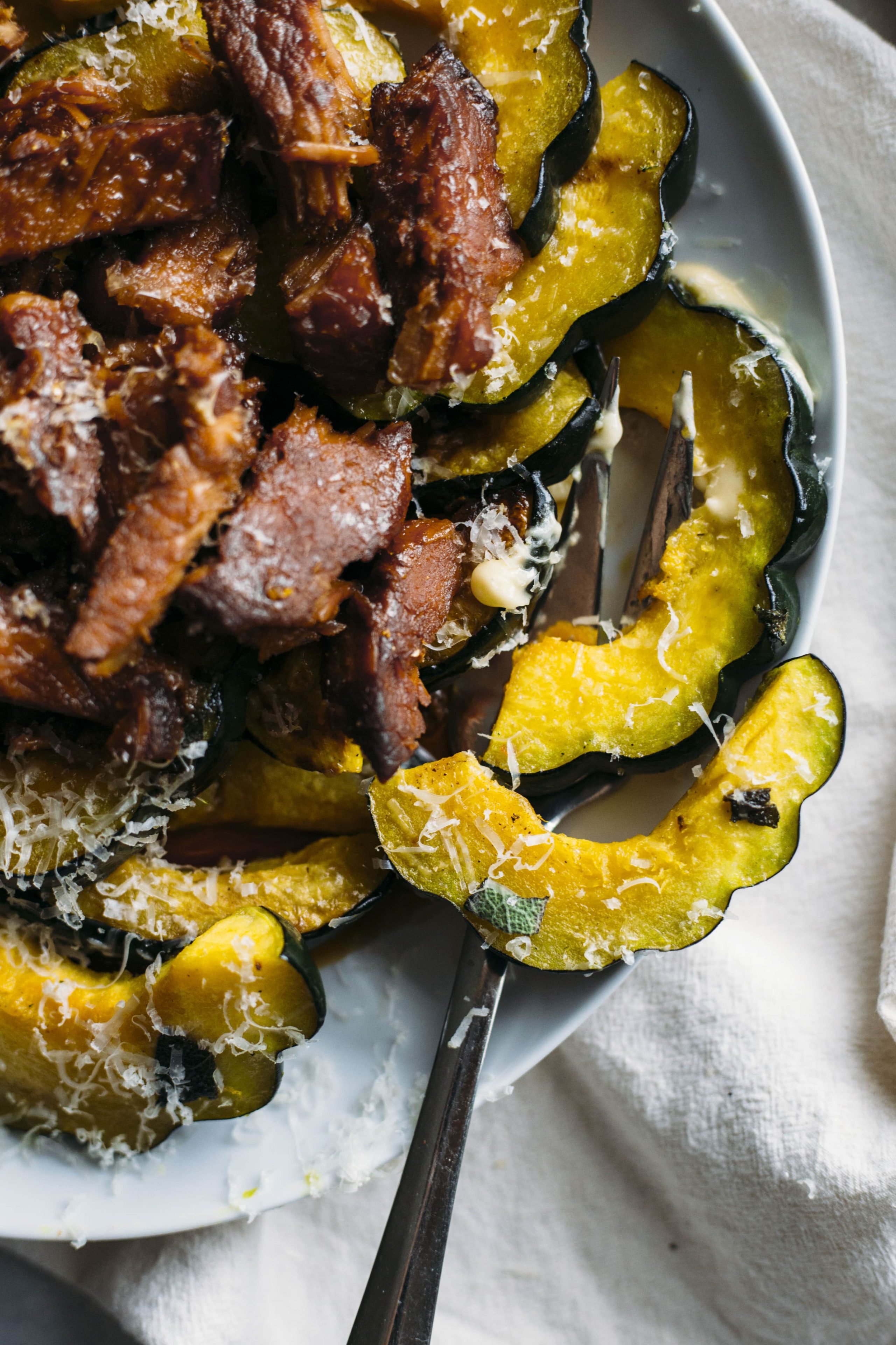 Roasted Acorn Squash | Acorn squash with sage and topped with honey ginger pork and cheese! A tasty way to enjoy squash | thealmondeater.com