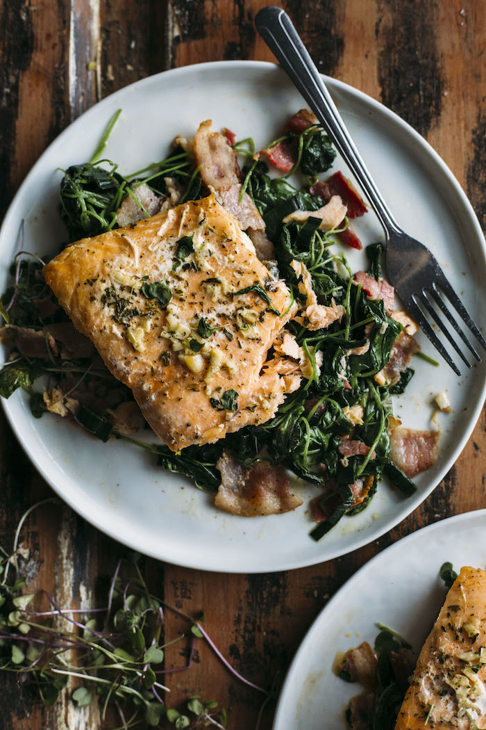 Whole30 Garlic Salmon | Salmon marinaded in garlic atop a bacon and watercress salad that's Whole30-approved | thealmondeater.com