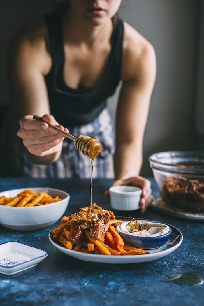 loaded sweet potato fries topped with pork+caramelized onion dipping sauce