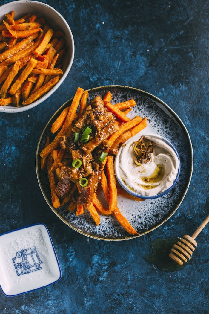 Loaded fries topped with honey ginger pork+caramelized onion dip