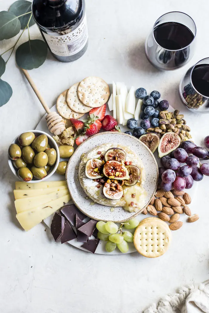 Summer Cheese Board Necessities, including a delicious baked brie topped with figs, pancetta and pistachios | thealmondeater.com