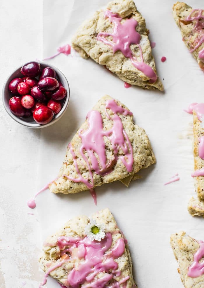 Apple Cranberry Scones - vegan-friendly scones filled with apples and topped with a sweet cranberry glaze | thealmondeater.com