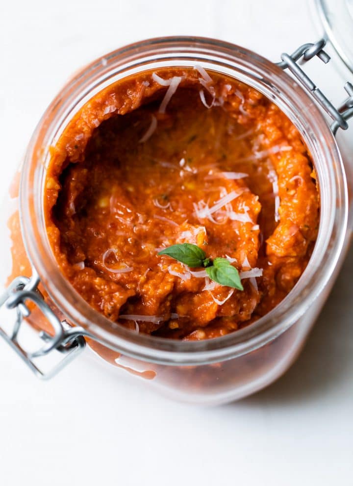 jar of sun dried tomato pesto topped with parmesan cheese