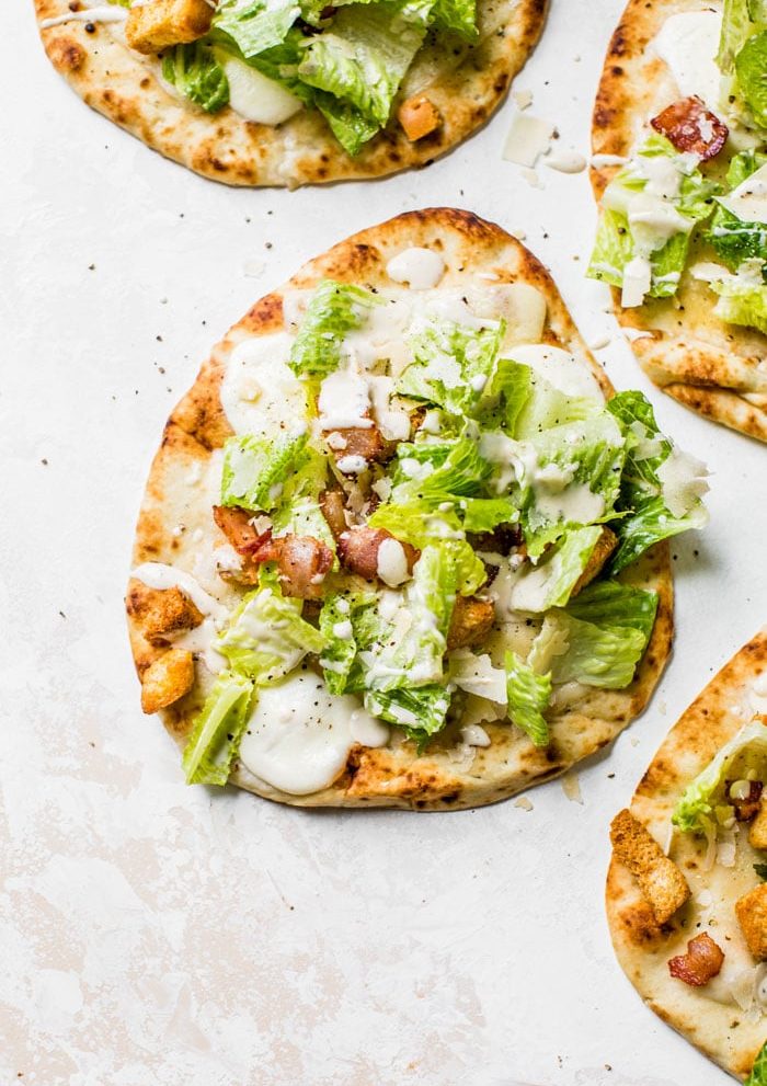 Caesar Salad Pizza made on naan bread for a single serve pizza recipe that's quick+healthy | thealmondeater.com