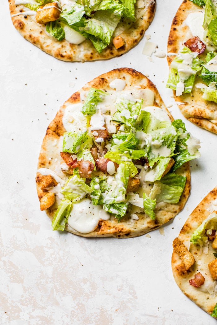 Caesar Salad Pizza made on naan bread for a single serve pizza recipe that's quick+healthy | thealmondeater.com