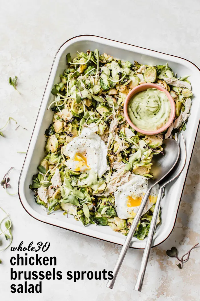 Chicken Brussels Sprouts Salad served with poached eggs and an avocado dressing #whole30 | thealmondeater.com
