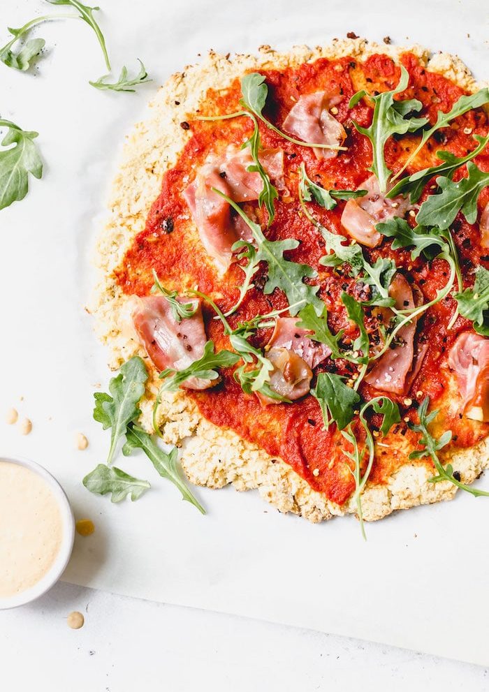 Whole30 pizza recipe made with cauliflower crust and your choice of toppings! #whole30 | thealmondeater.com