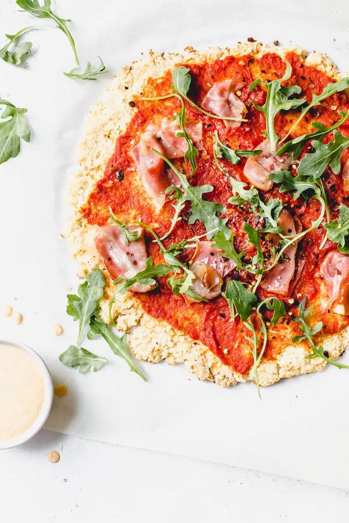 Whole30 pizza recipe made with cauliflower crust and your choice of toppings! #whole30 | thealmondeater.com