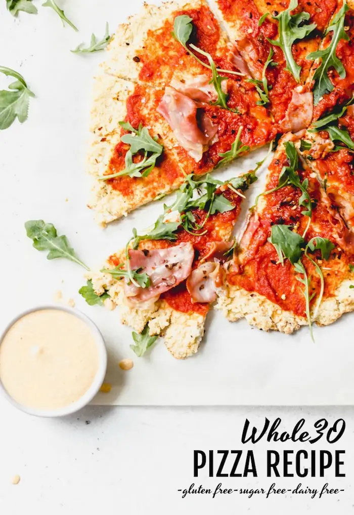 Whole30 Pizza Recipe - pizza made with cauliflower crust and topped with simple ingredients for you on your whole30! | thealmondeater.com