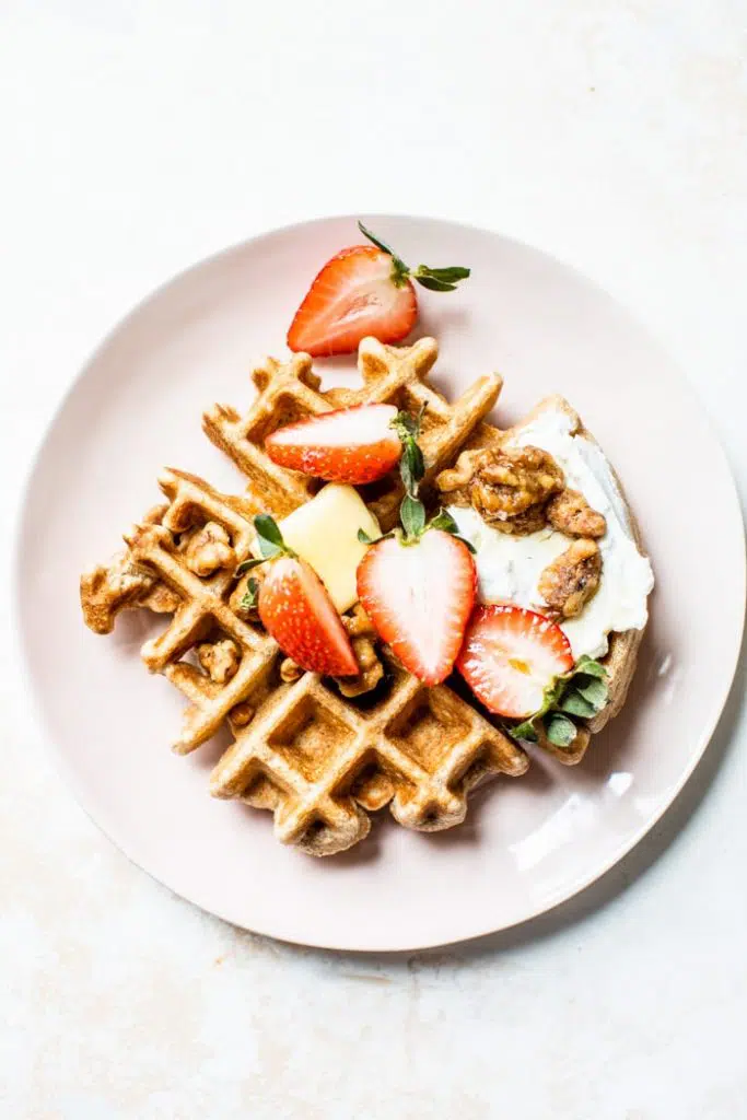Fluffy Whole Wheat Waffles that are made with whole wheat flour, coconut oil and maple syrup for a healthier breakfast option | thealmondeater.com