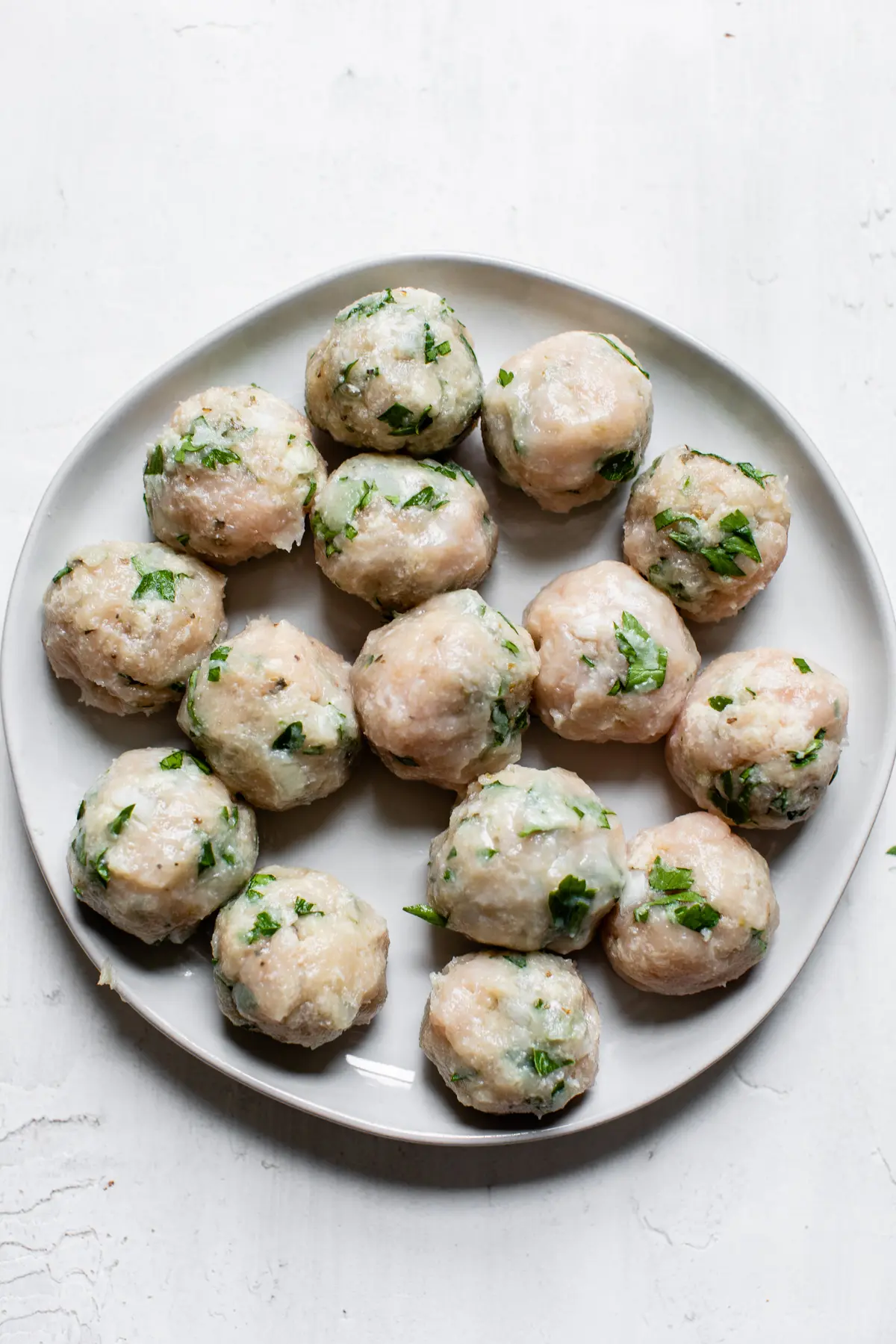 uncooked meatballs on a plate