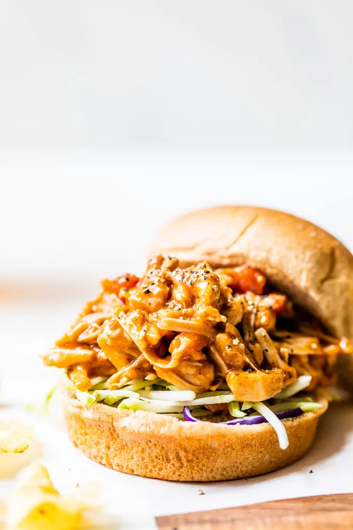 A hamburger bun filled with barbecue pulled jackfruit