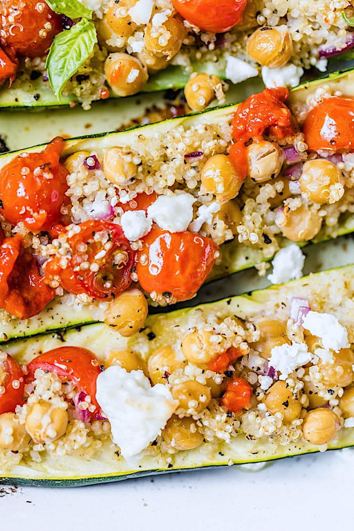 Zucchini boats filled with quinoa, tomatoes and feta cheese