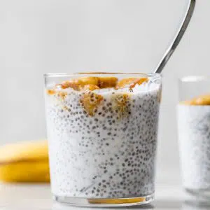 milk and chia seeds in a glass topped with bananas