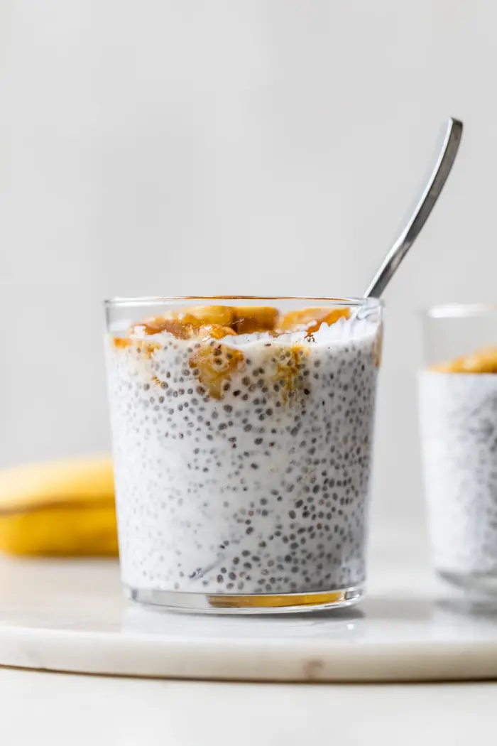 milk and chia seeds in a glass topped with bananas