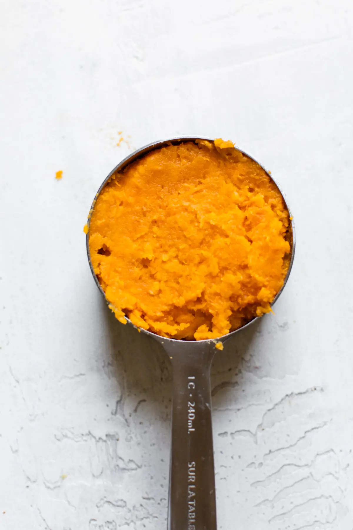 mashed sweet potato in a measuring cup