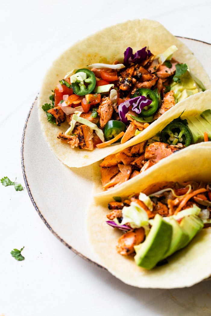 tacos filled with salmon, jalapeño and avocado