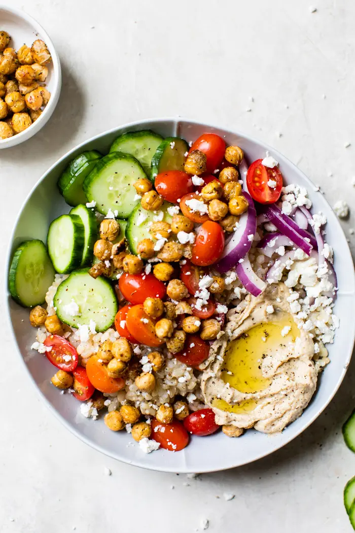 bowl filled with rice, vegetables and feta cheese