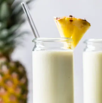 smoothie in a glass with a pineapple wedge