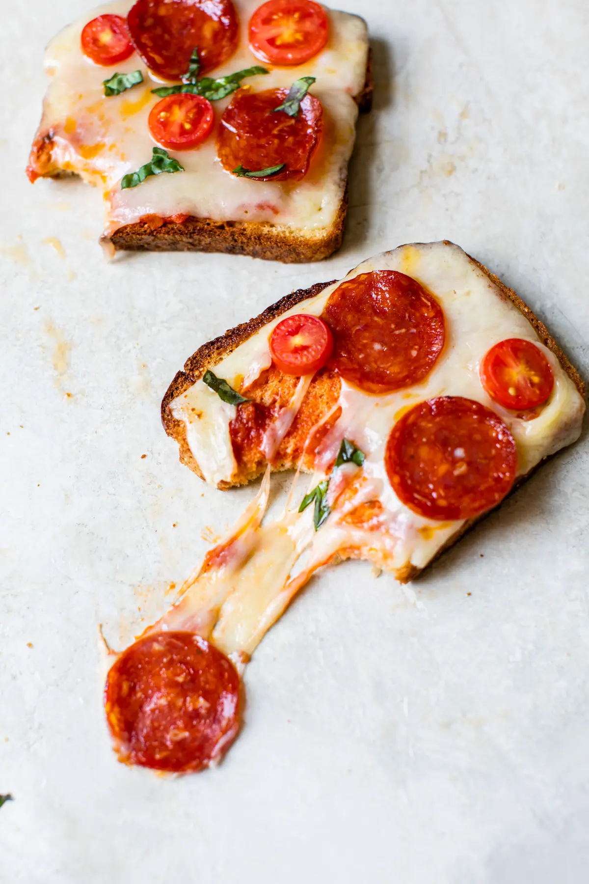 a slice of toast topped with cheese and pepperoni