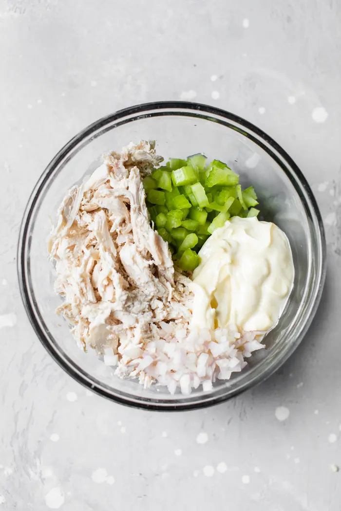 shredded chicken, celery and mayo in a bowl