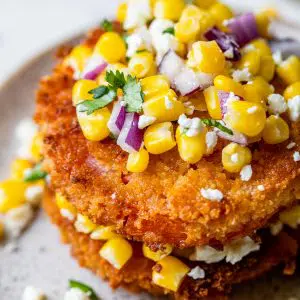 fried tomato slices topped with corn