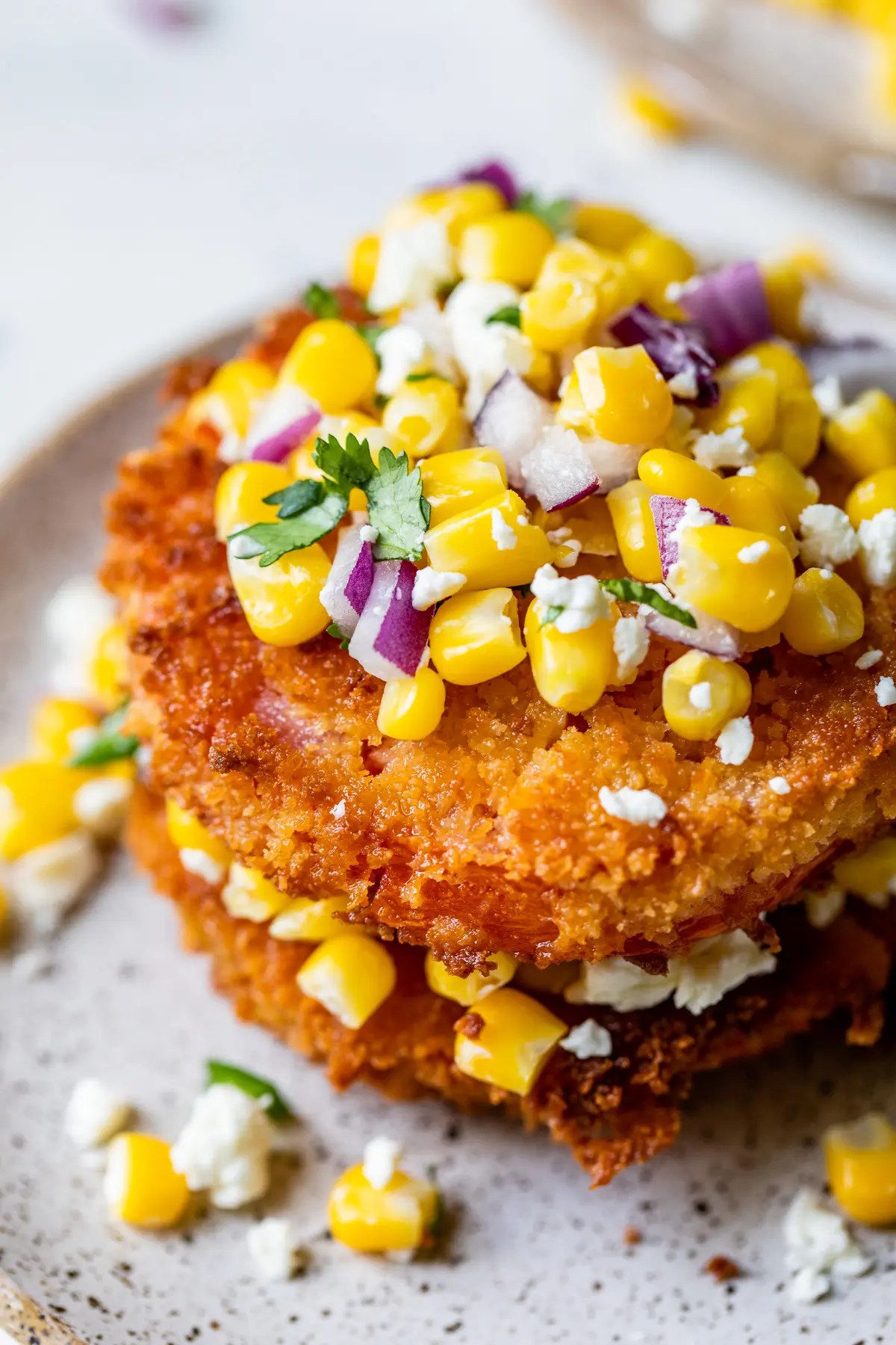 fried tomato slices topped with corn