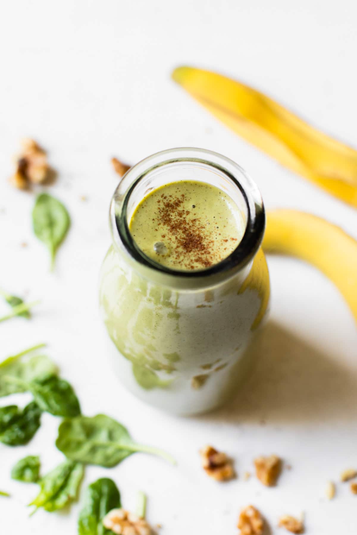 green smoothie in a glass bottle