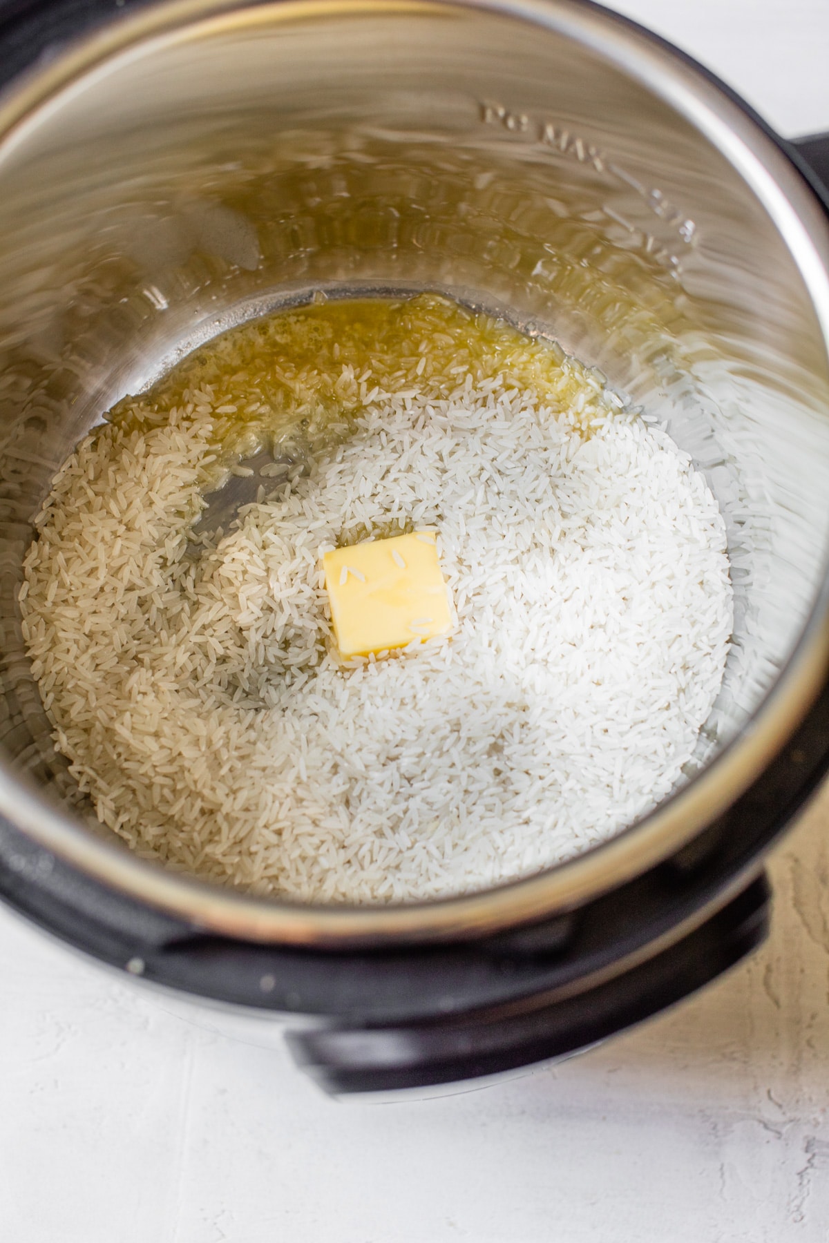 rice and butter in a pressure cooker