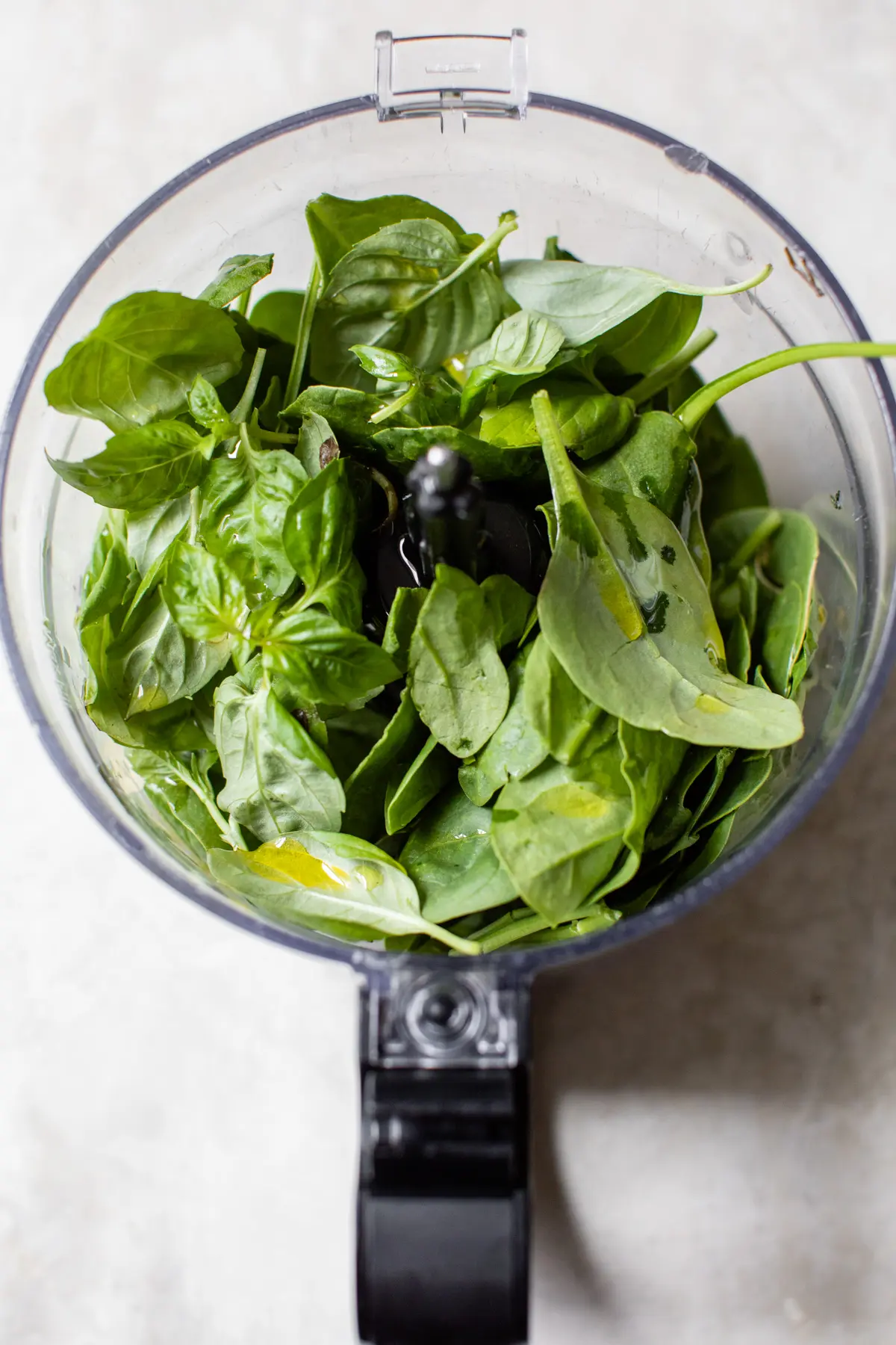 spinach and basil in a food processor