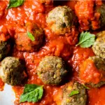 meatballs in a skillet topped with marinara sauce