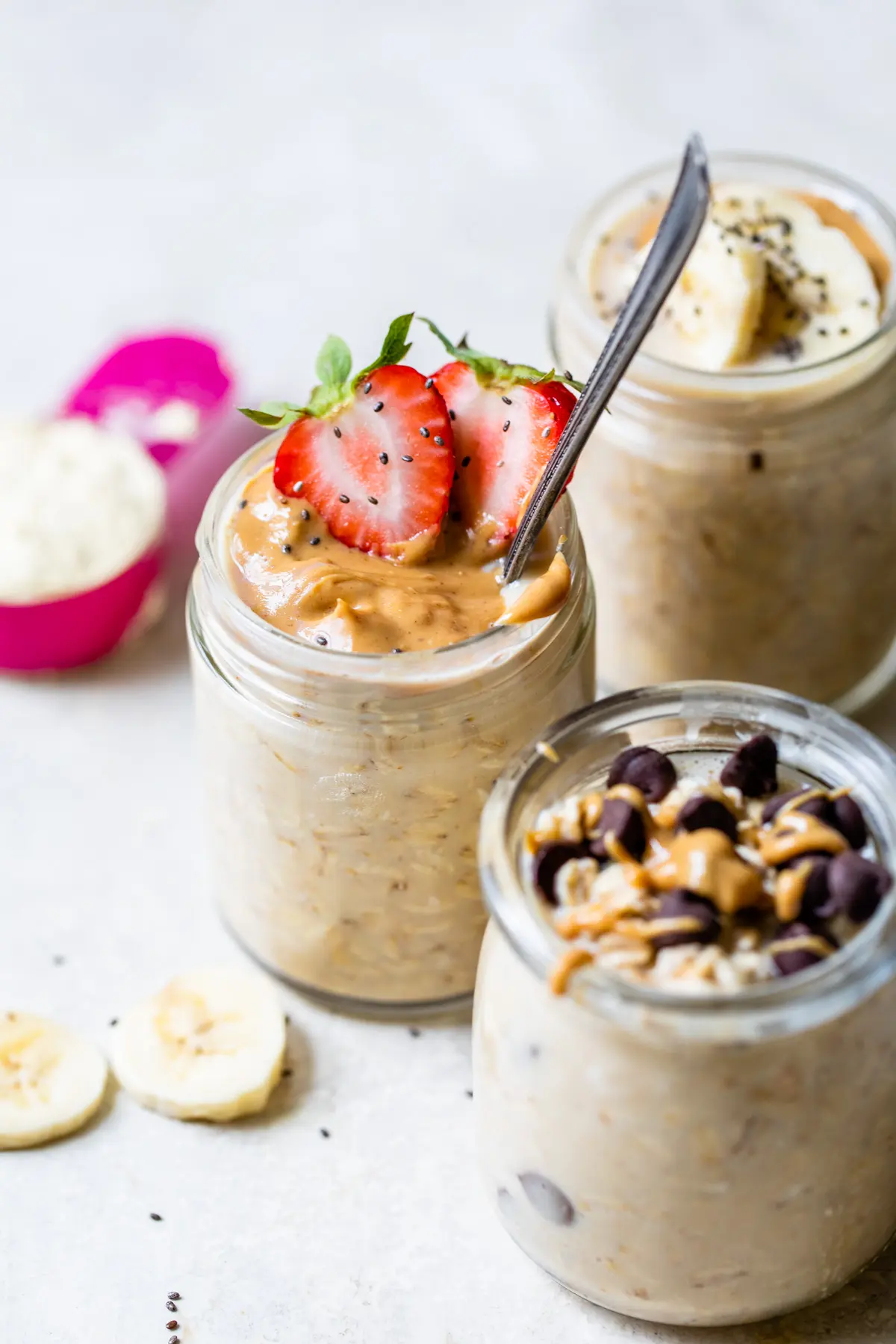 oats in a jar topped with peanut butter and strawberries