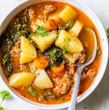 a bowl of soup with sausage and potatoes