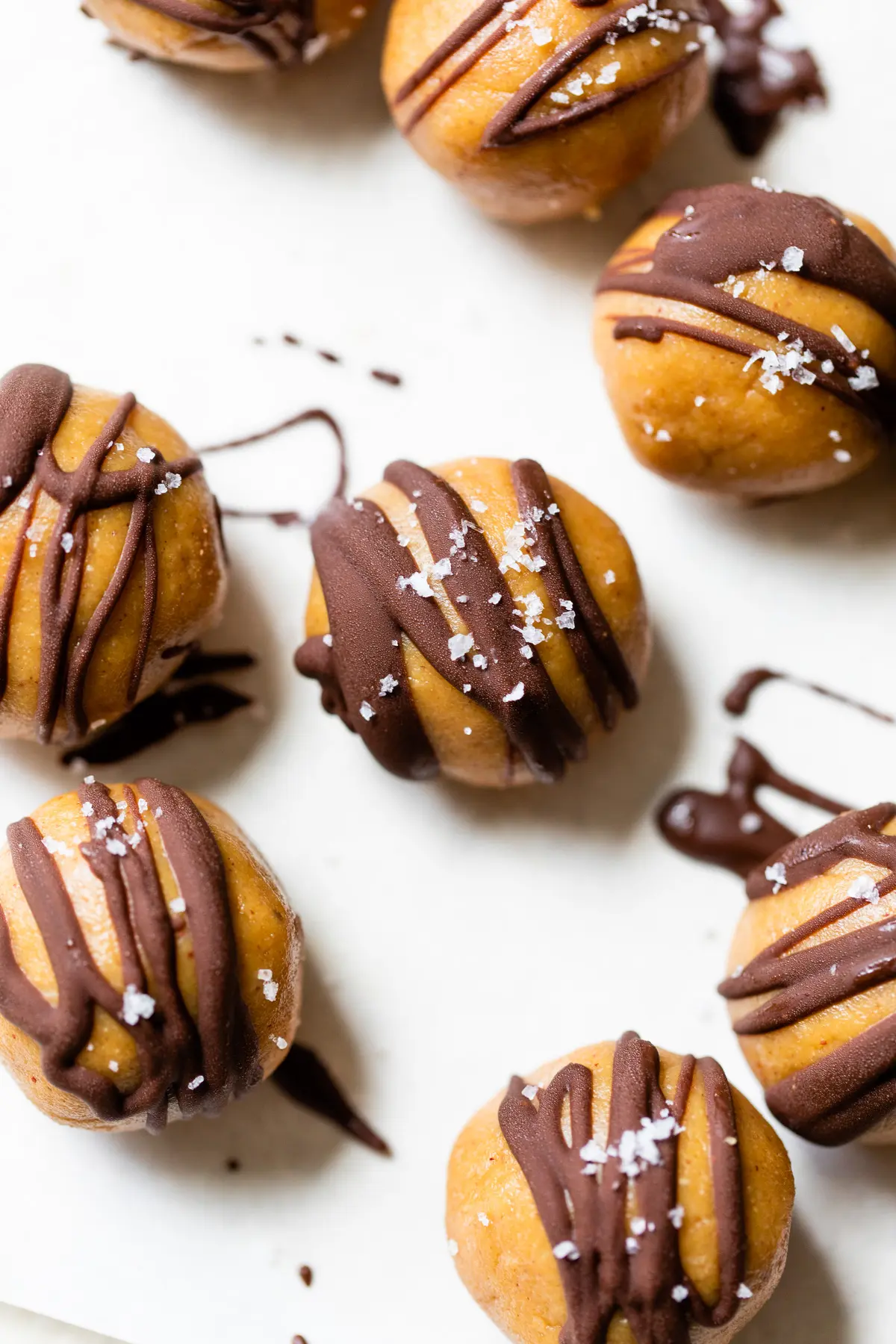 peanut butter balls with a chocolate drizzle