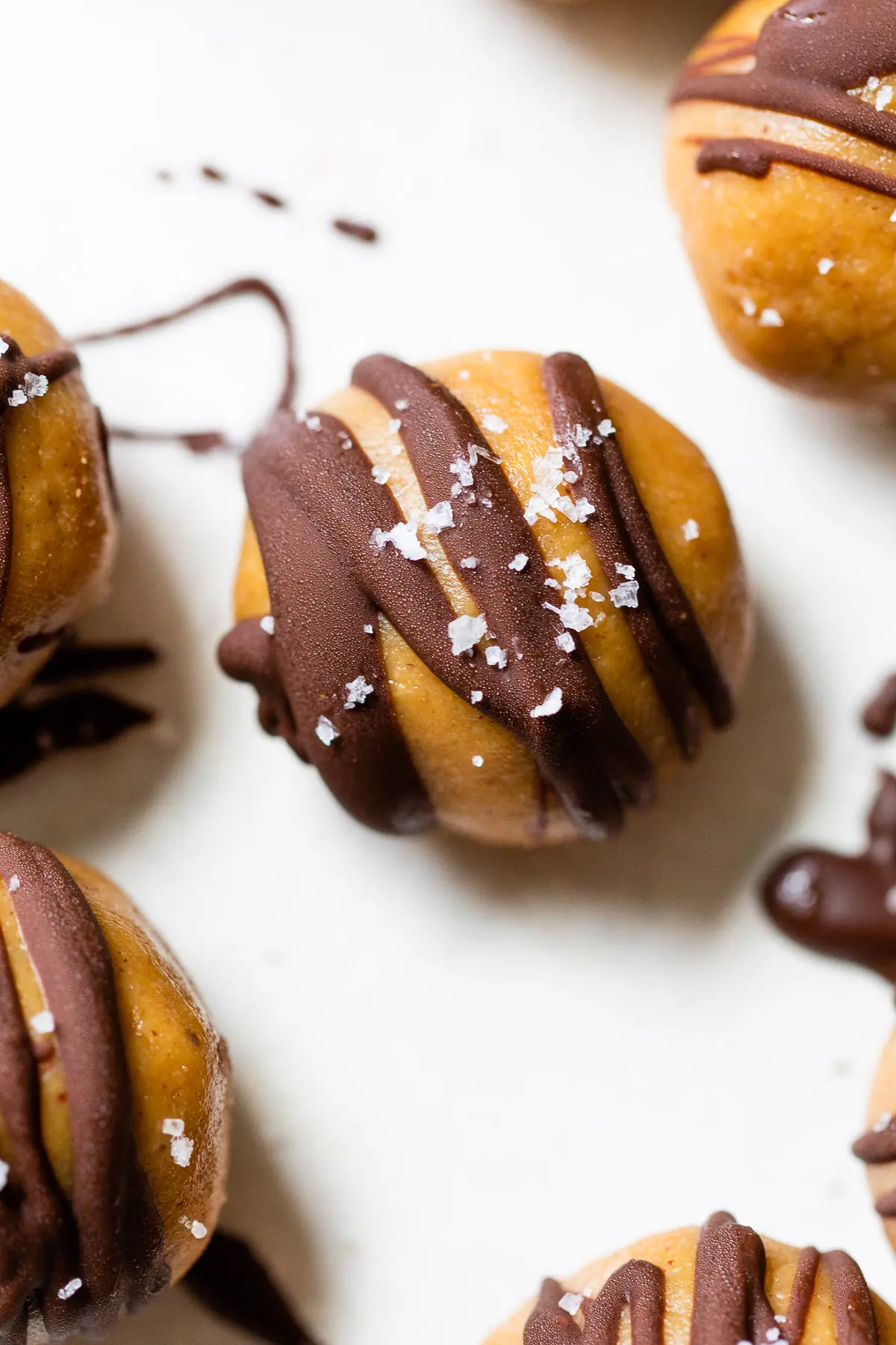 close up of a ball drizzled with chocolate and sea salt