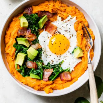 sweet potatoes topped with bacon, egg, spinach, and avocado