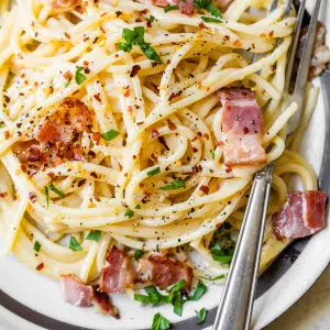 pasta on a plate with bacon and cheese