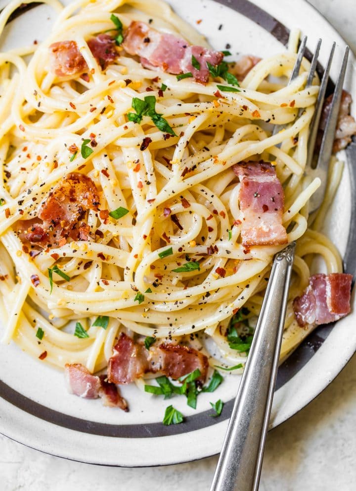 pasta on a plate with bacon and cheese