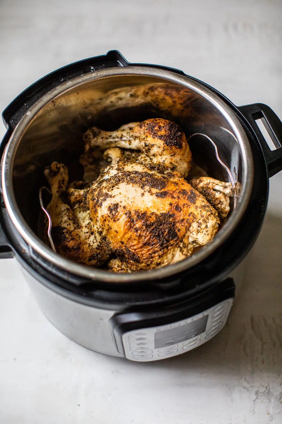 whole chicken inside of a pressure cooker
