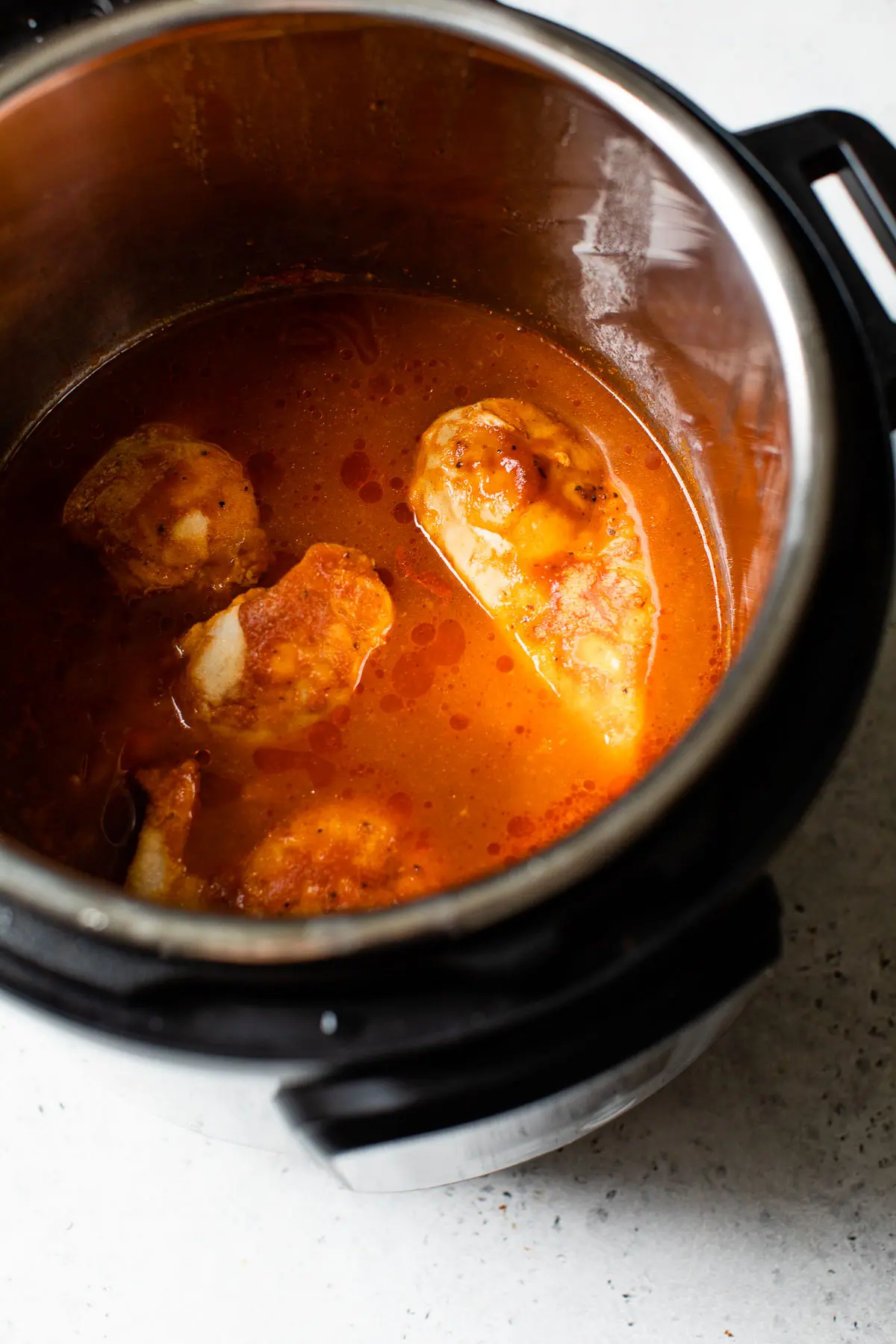 cooked chicken in a pressure cooker with bbq sauce