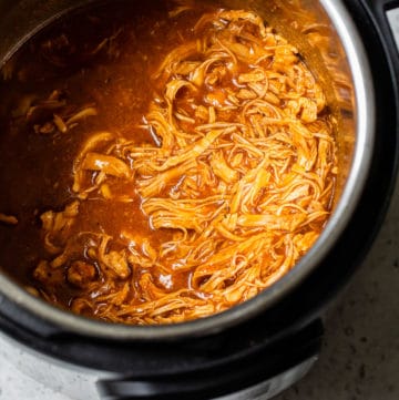 shredded chicken with bbq sauce in a pressure cooker