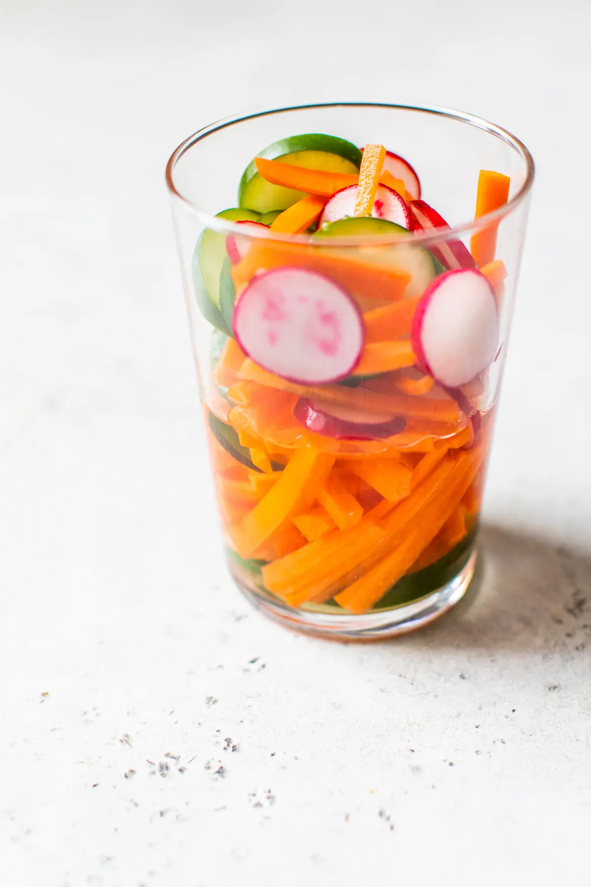 sliced vegetables in a cup with vinegar