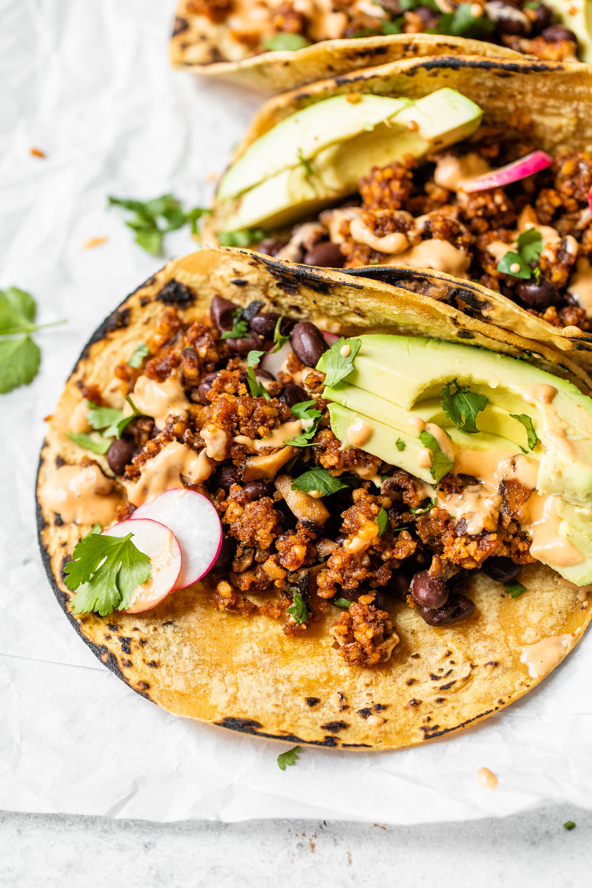 close up of a taco filled with walnut taco meat and avocado