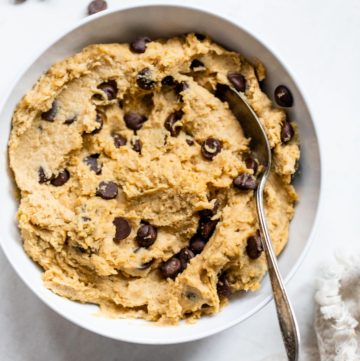 big bowl of cookie dough with chocolate chips and a spoon